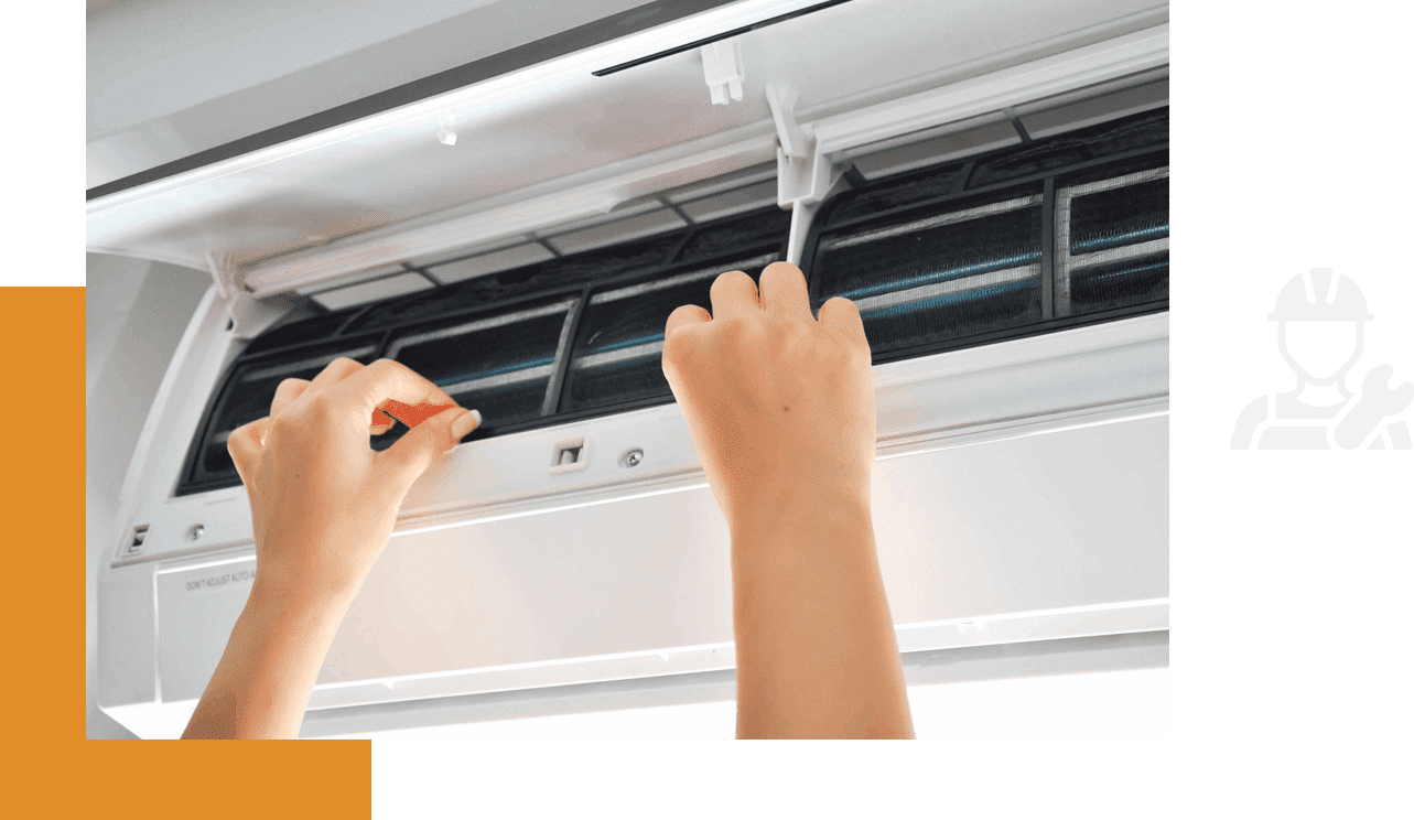 A person is cleaning the air conditioner with a brush.