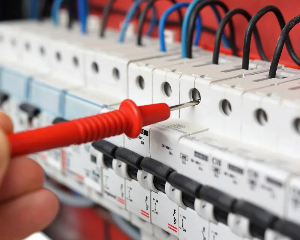 A person is working on an electrical panel.