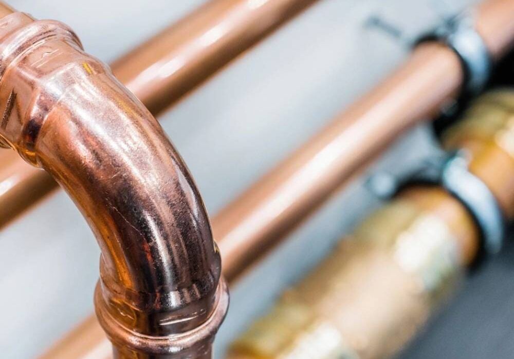 A close up of copper pipes and valves